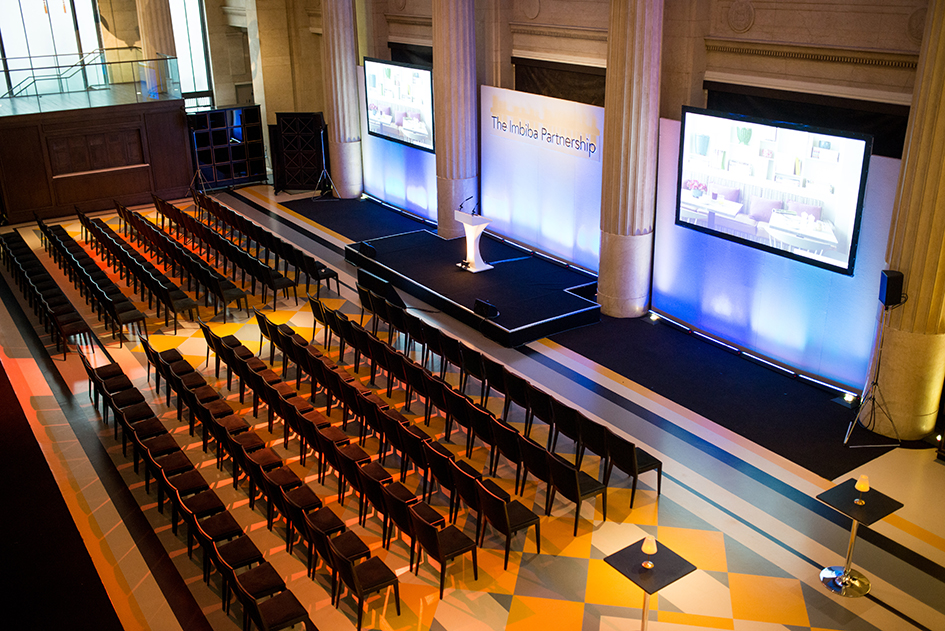 Banking Hall interior, 6 rows of seating, 30 chairs a row, set up for a presentation shown on three large screens