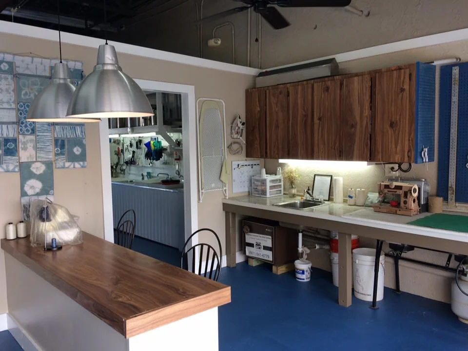 Designated Sewing area with large cutting table, sewing machines, serger, le-clerc floor loom available to rent by month