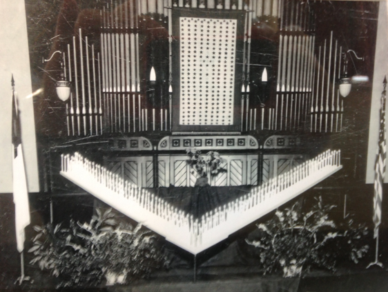 Façade of the Pilcher pipe organ in use at First Baptist from 1887 until 1949. Photo taken on Christmas Eve 1944 during a candlelight service for men and women serving in the military.