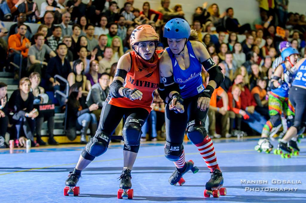 Manhattan jammer J-Rod Maven edges past Brooklyn blocker B'Zerk on her way to becoming her team's MVP for the game. Photo by Manish Gosalia.
