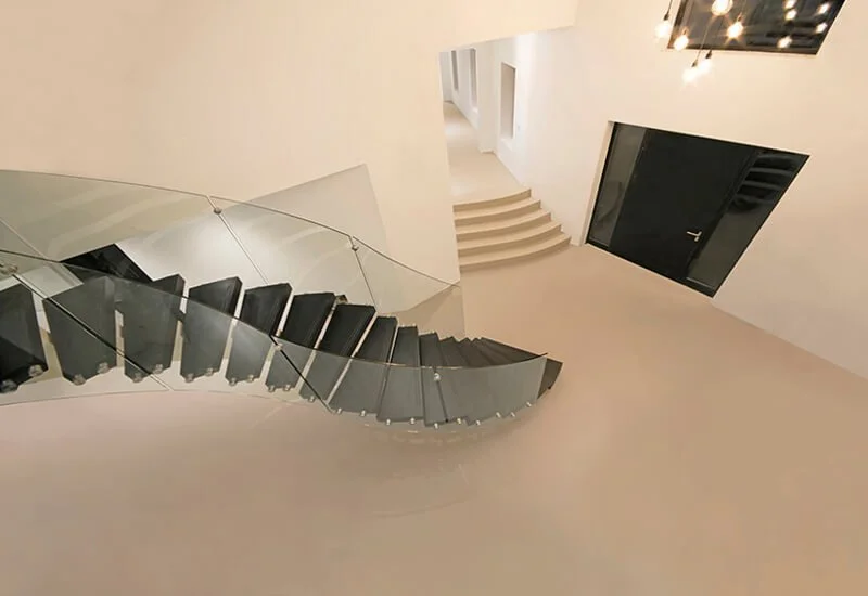 Neutral resin flooring provides a durable and elegant foundation for a contemporary living space with resin steps.