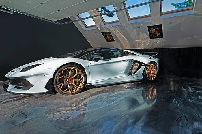 Expertly installed epoxy flooring provides a seamless and durable base for a luxury supercar.