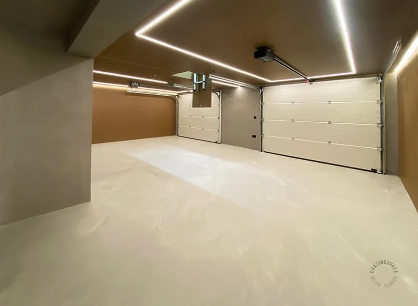 Modern garage featuring Mistral Blend Resin in Gentle Shade for the floor and Microcement on the walls. 

Our PU Floor offers a natural concrete look. This is both attractive and highly durable, making it ideal for showcasing cars in style. 

If you 