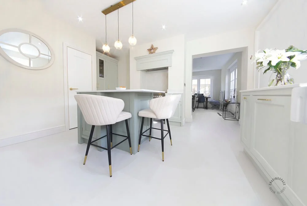 The space is tied together with a chic, seamless grey resin floor.