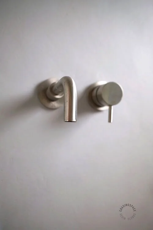 Minimalist bathroom wall detail showcasing seamless Microcement finish.