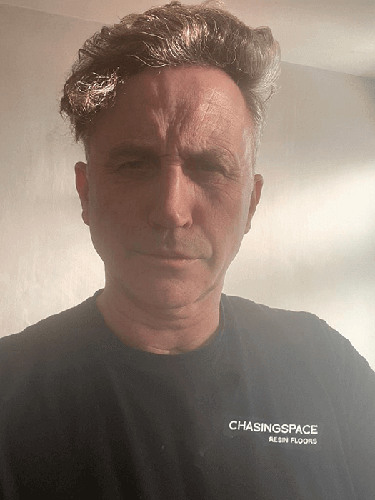 Portrait of a director in natural light, wearing a Chasingspace Resin Floors t-shirt.