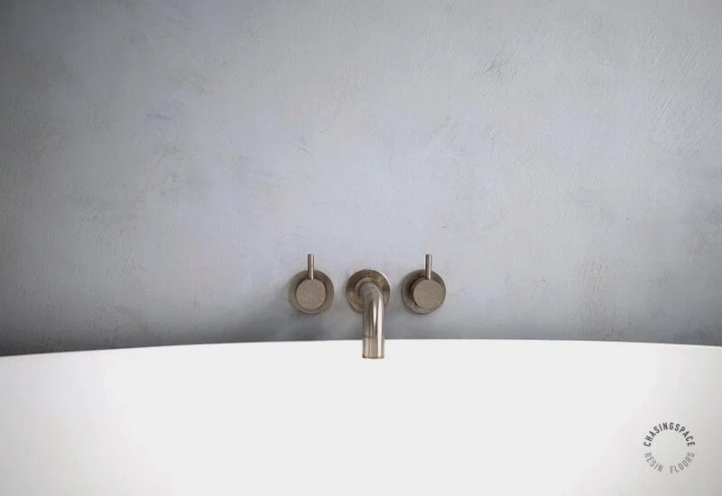 Subtle variations within the light grey Microcement finish, highlighting modern bathroom design.