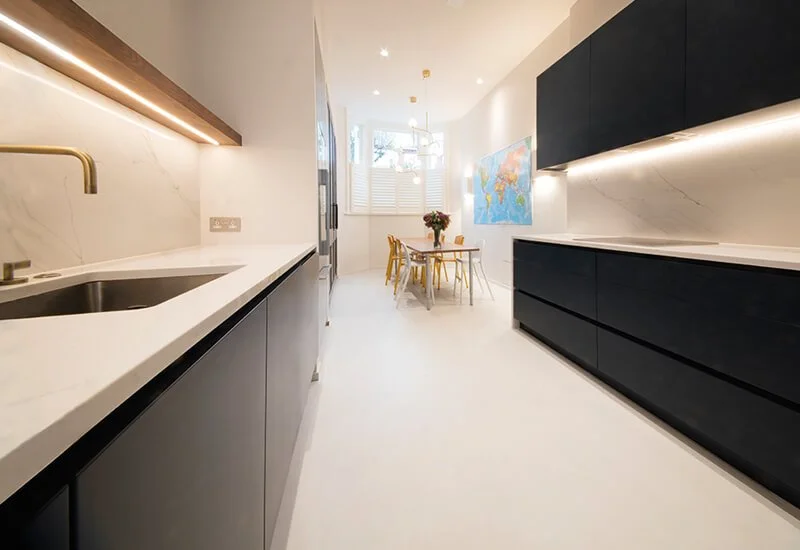 A chic, modern kitchen featuring a seamless light two-colour resin floor that creates a clean and minimalist aesthetic.