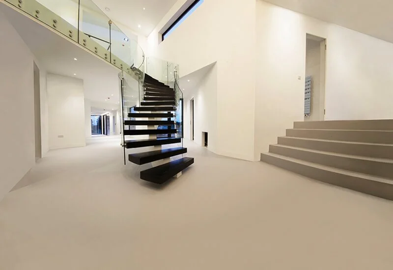 Modern architectural design showcasing a sleek resin floor and a set of matching resin steps.