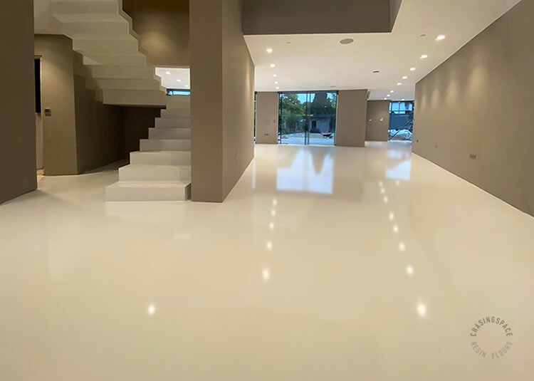 Beige epoxy flooring adds a sense of spaciousness to this modern home interior.