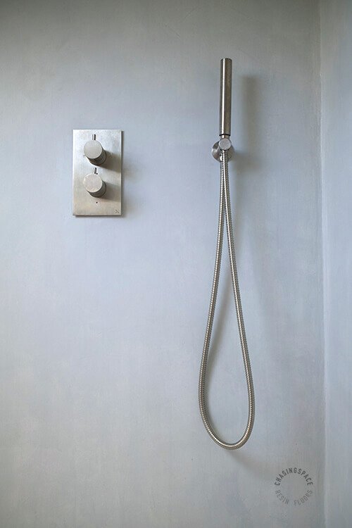 Contemporary shower area finished in smooth, durable Microcement.