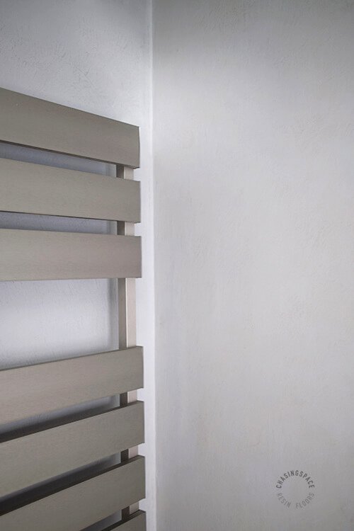 Clean lines and Microcement walls defining modern bathroom design aesthetics.