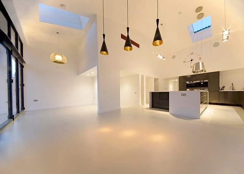A new kitchen featuring a seamless, smooth resin floor, perfect for modern living and ease of maintenance.