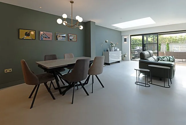 Open-plan living area showcasing a sleek grey resin floor.