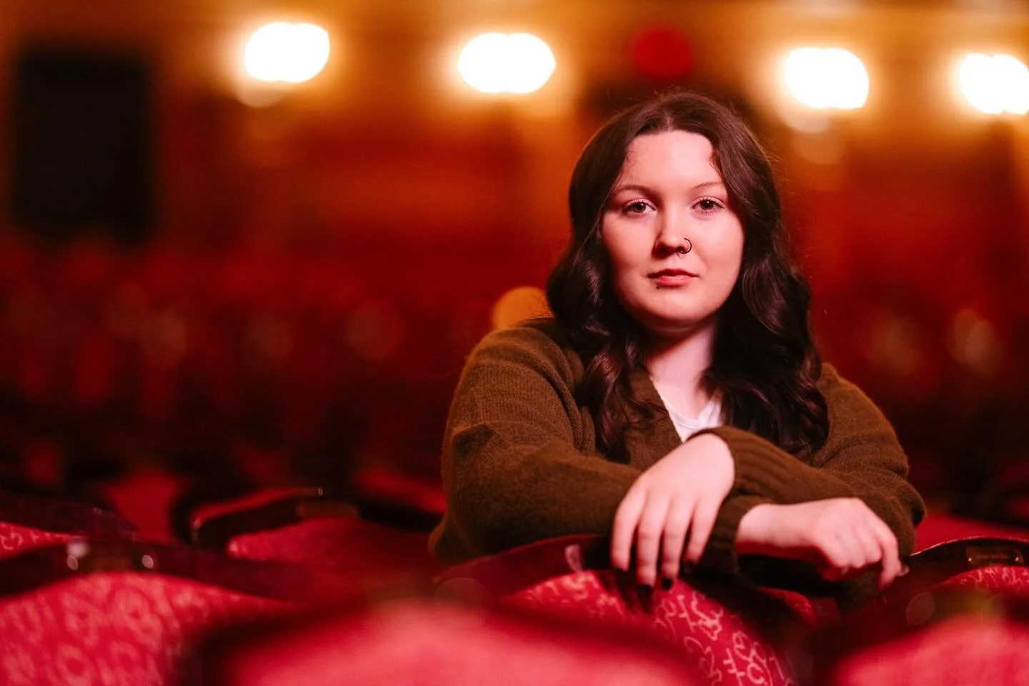 &ldquo;The velvet curtain, deep and still,
A world held captive, waiting, chill.
Then music swells, a whispered sigh,
As lights ignite a painted sky.&rdquo;

Harley - Reeths Puffer High School 2026