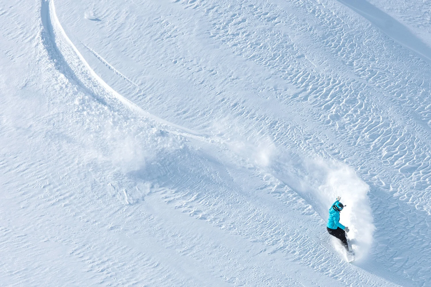The key graphic element is the ski track, visualised as a singular line used to connect messages and imagery.