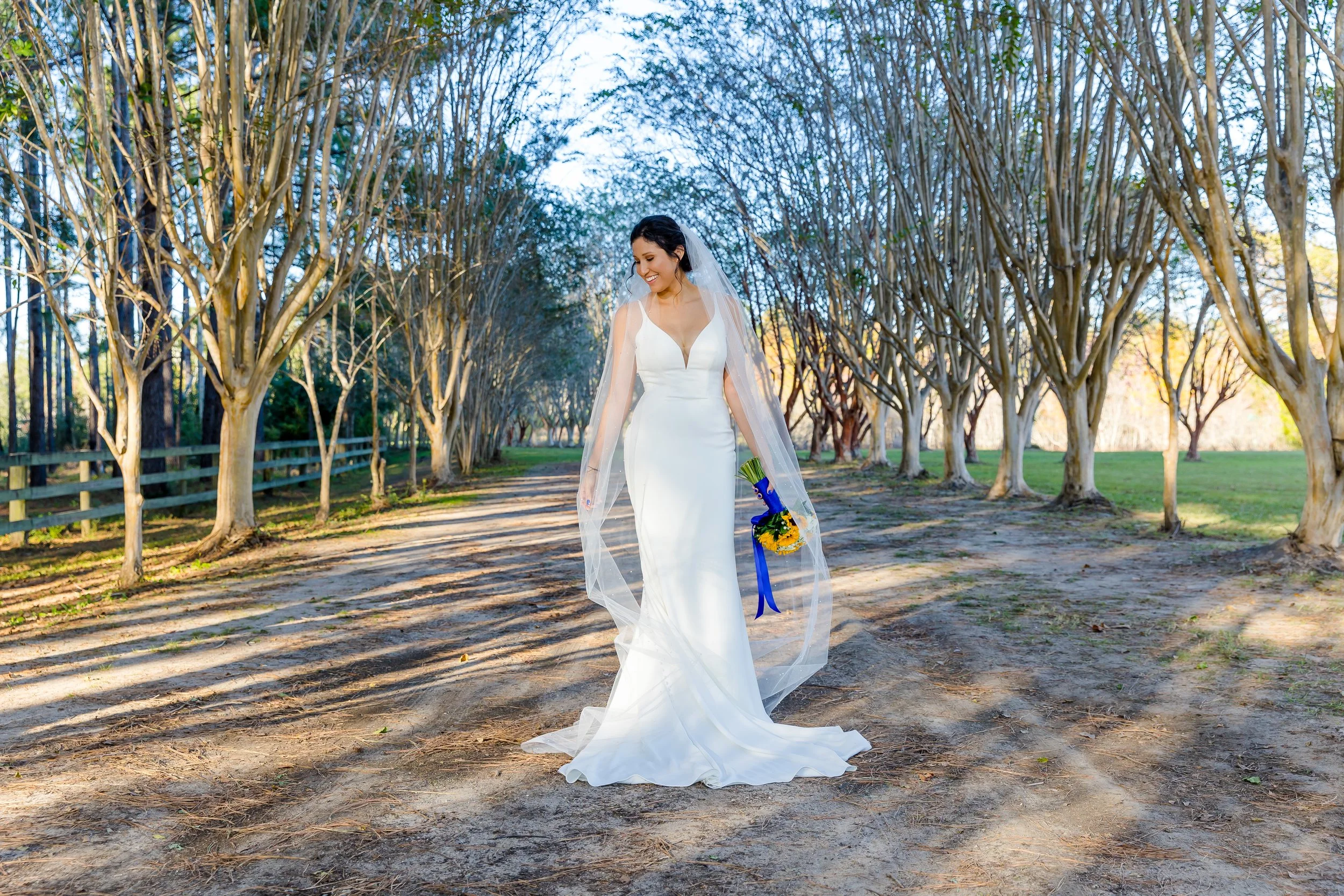 stunning bride standing on a dirt road in milton florida picture taken by Jacksonville beach and St. Augustine wedding photographer