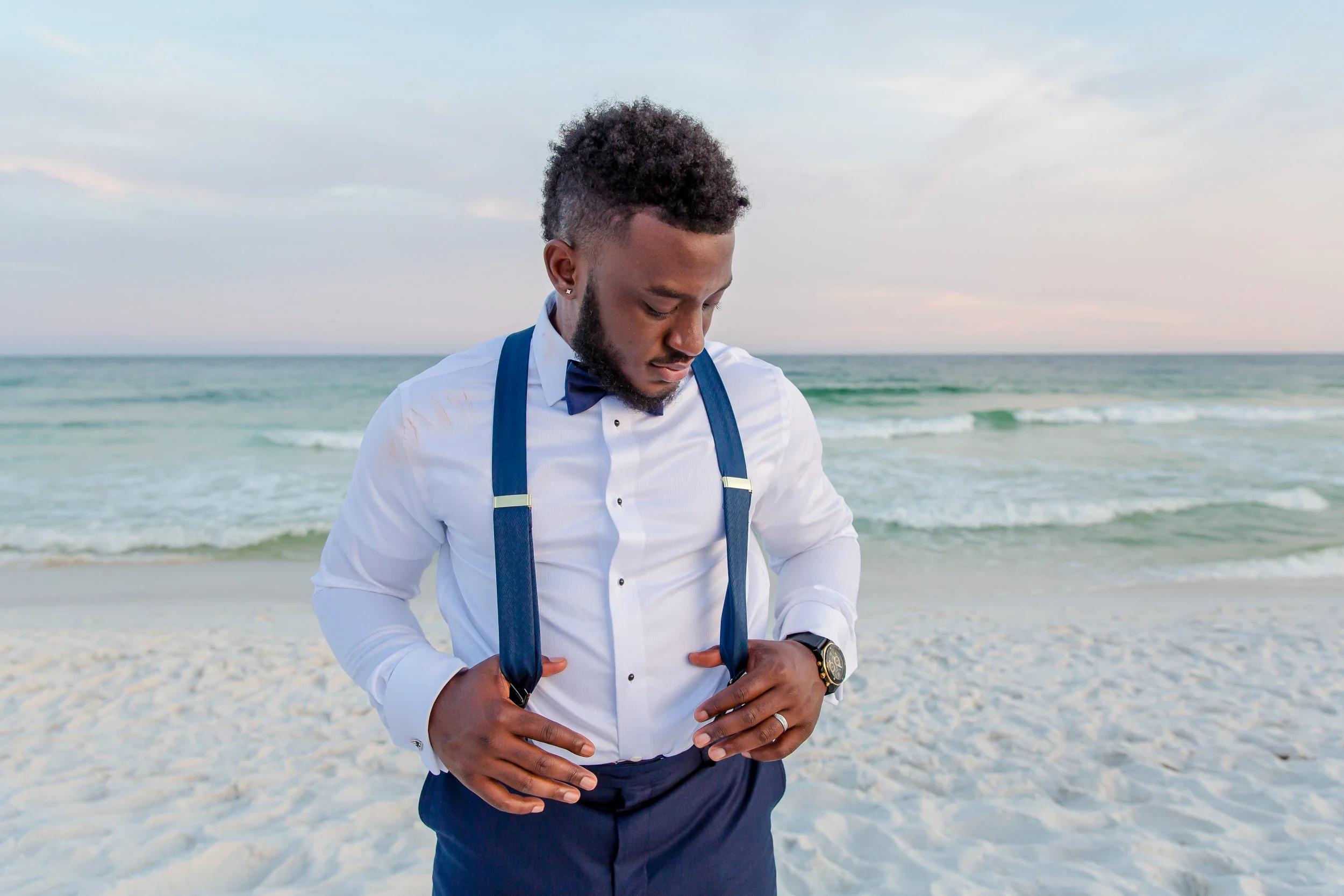Handsome groom standing on white sandy Destin beaches. Photographed by St Augustine and Jacksonville Florida Wedding photographer