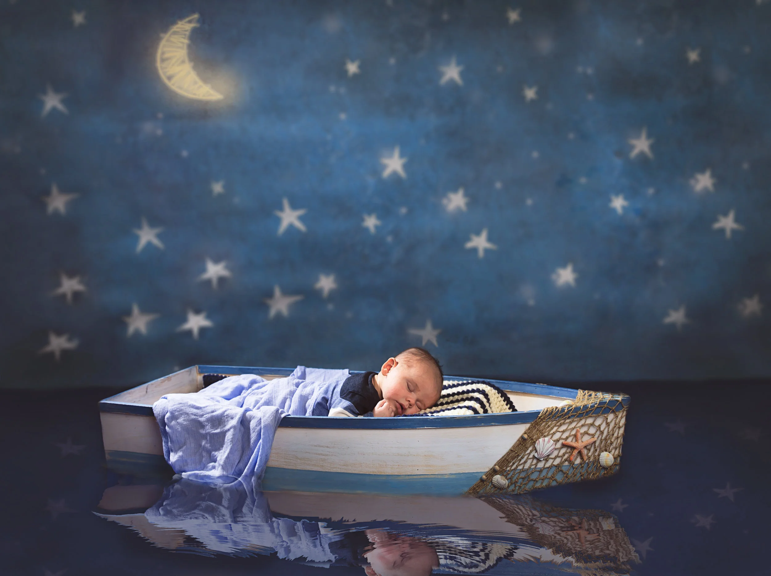 Sleeping newborn baby in a moon and stars themed portrait by Inspired By You Photography in Navarre, Florida.
