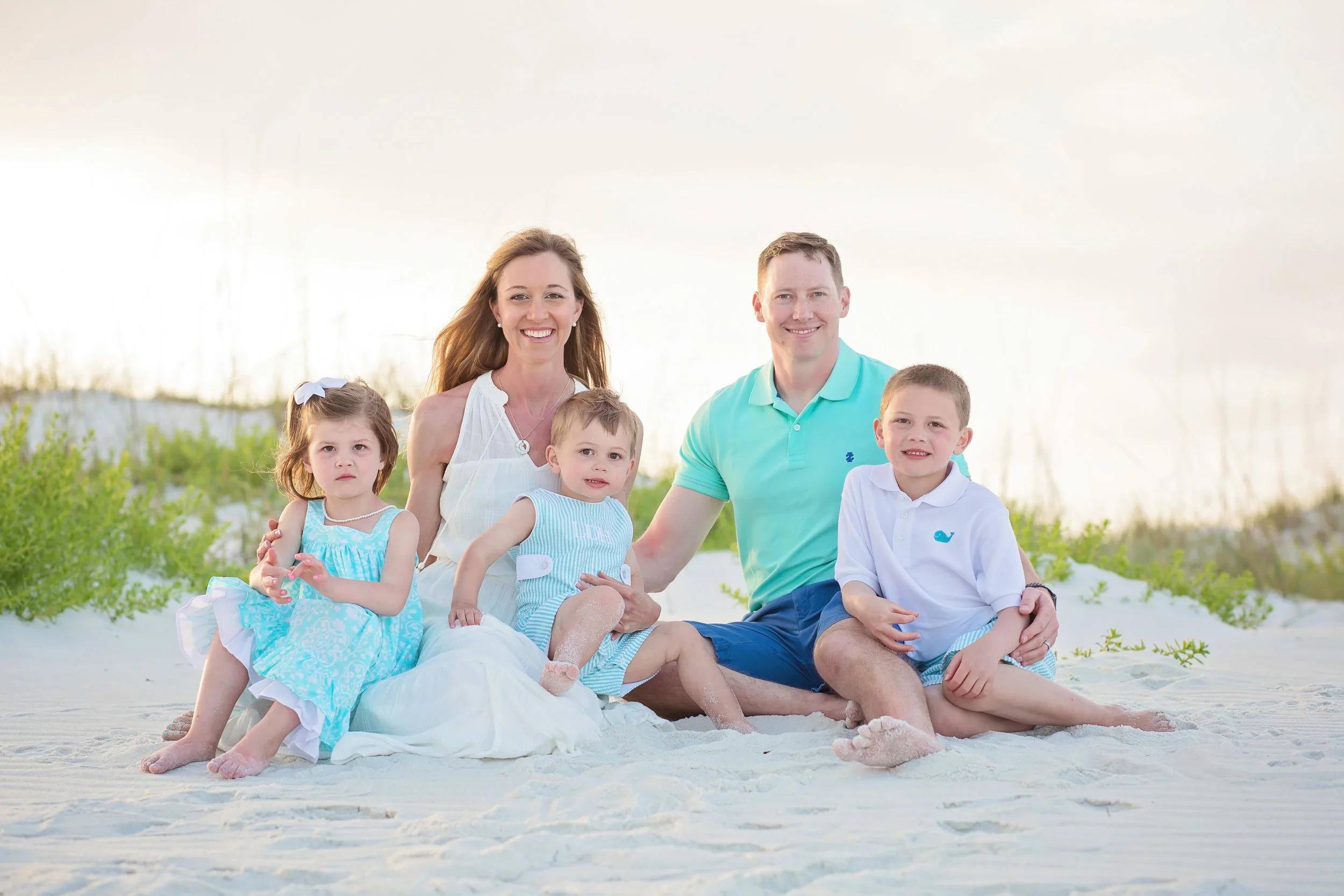 Navarre Beach family photographer capturing parents and three children during a family beach photography session