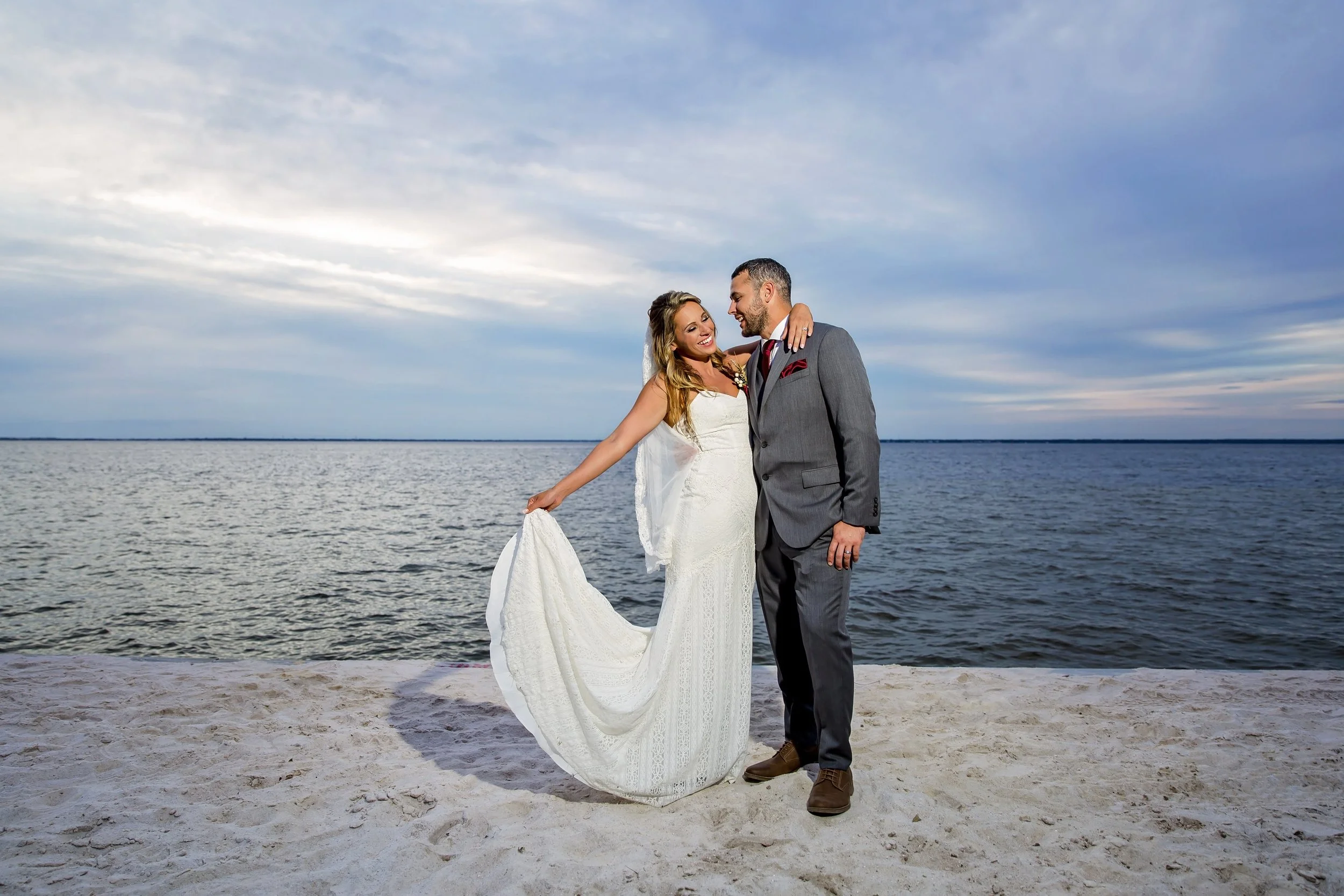 Bride and groom standing the white sand of Destin Floridas beaches photographed by a Jacksonville St. Augustine beach photographer