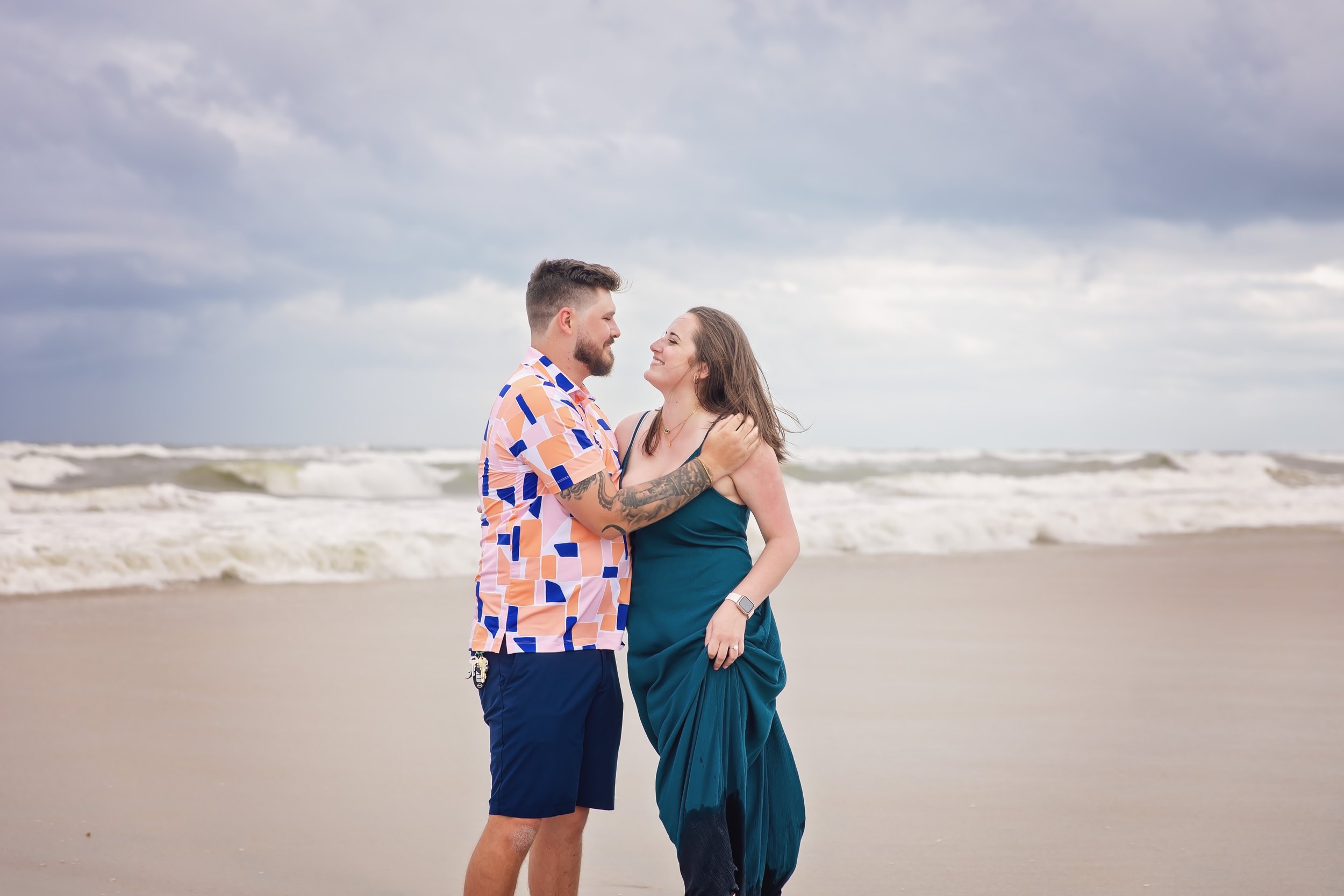 Engaged couple takes pictures on St. Augustine Beach in Florida