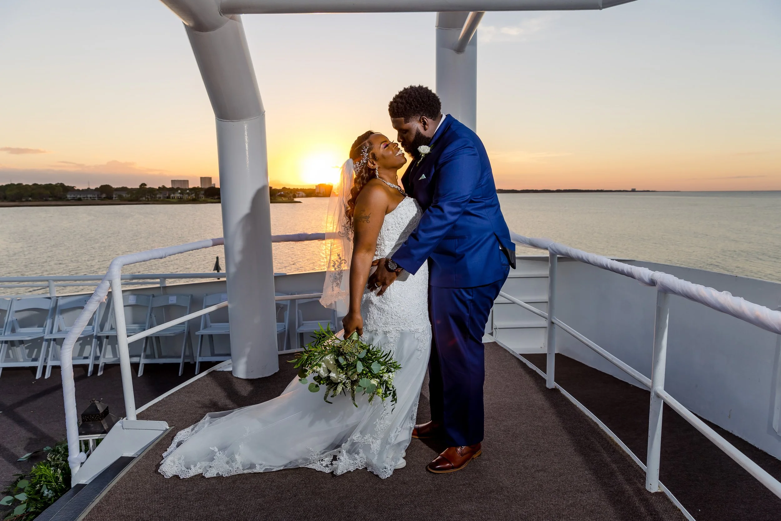Sunning bride and groom standing on the top deck of a yacht at sunset  photo taken by Jacksonville-Florida St.Augustine-wedding-photographer