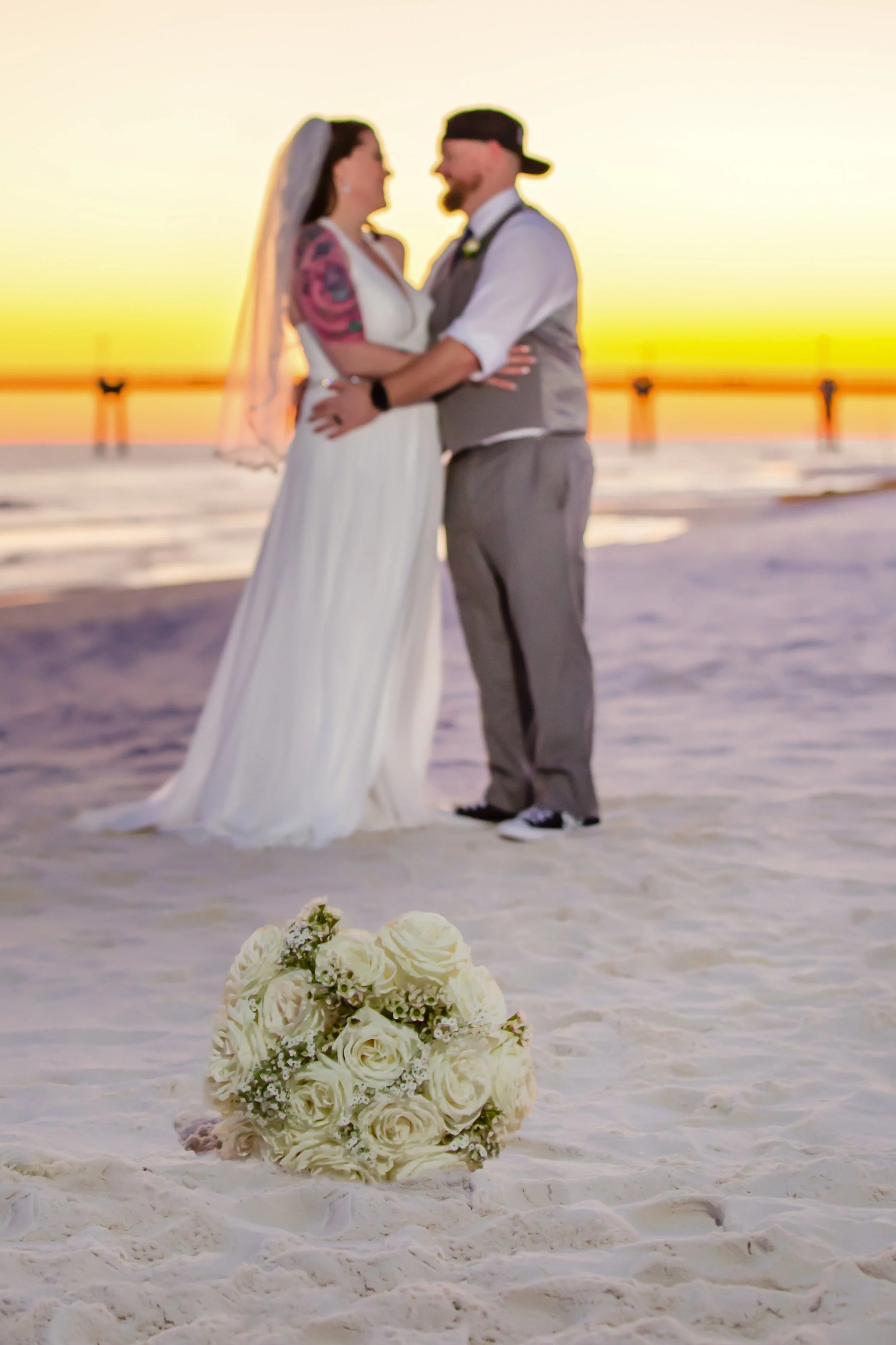 bride and groom Sunset embrace on Fort Walton Beach Florida white sandy Beach Picture taken by a Jacksonville and St. Augustine Florida Photographer