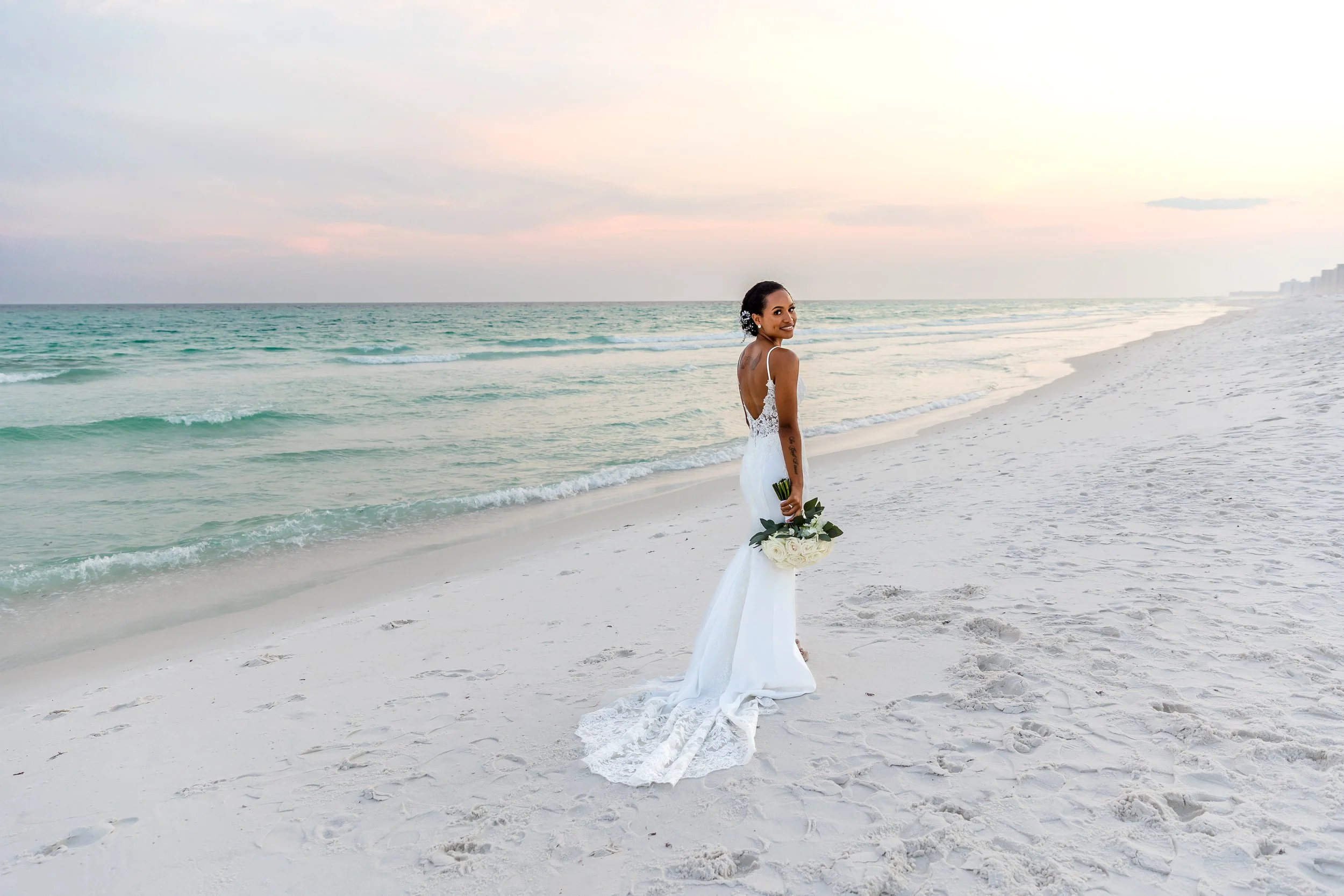 Bride standing on the white sand beaches of Henderson Beach Florida Picture taken by St. Augustine and Jacksonville Florida wedding photographer