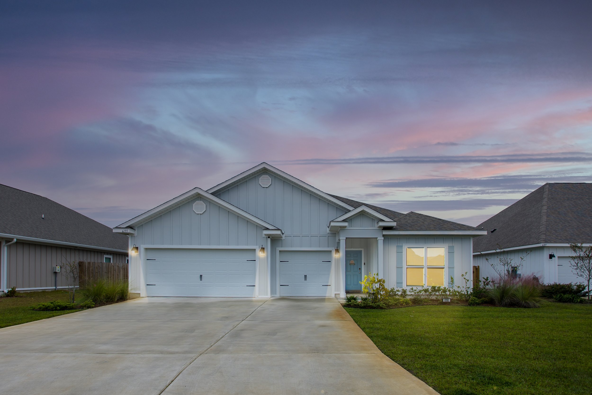 Professional real estate photography of a modern Florida home exterior photographed at dusk