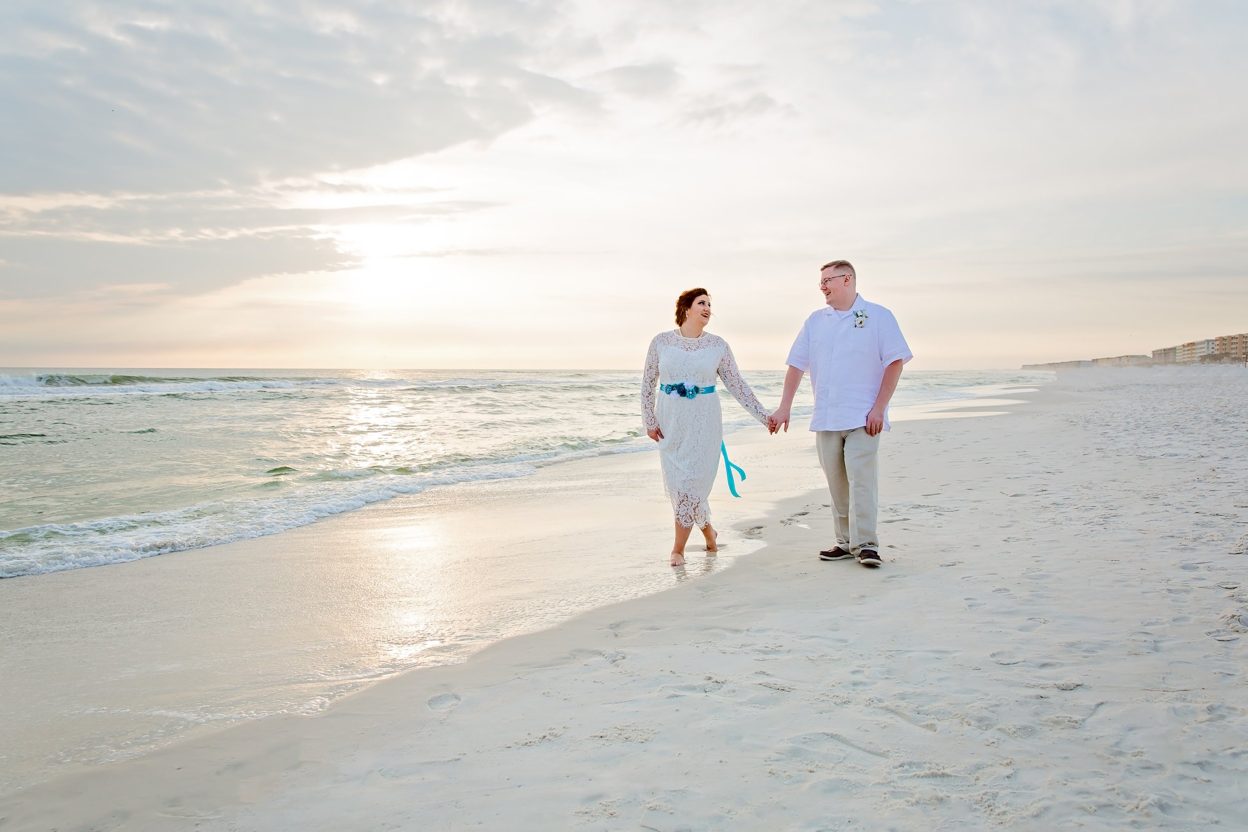 Bride and Groom holding hands with each other on the white sand of Destin Beach Florida photographed by Jacksonville Florida St .Augustine wedding photographer