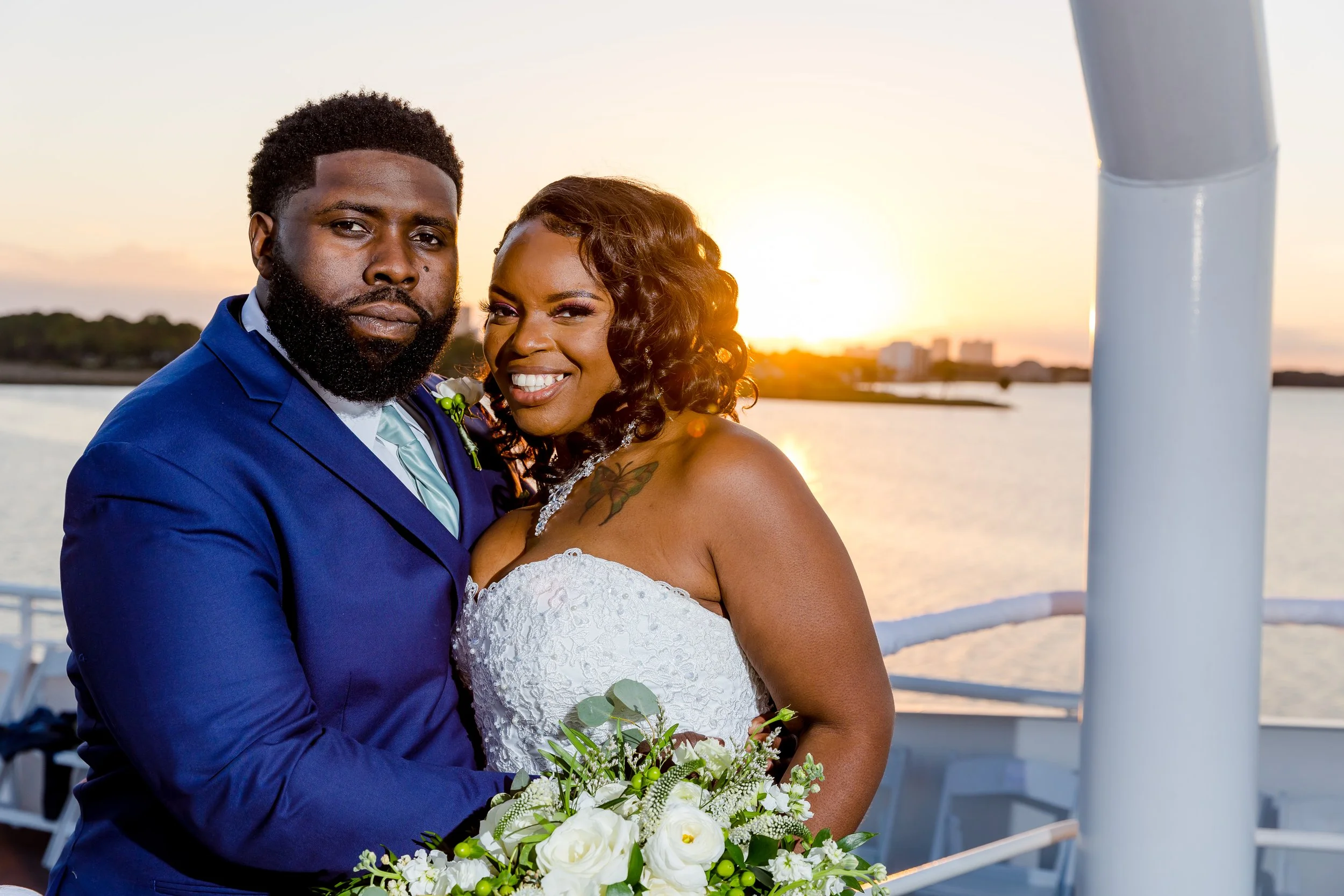 Sunning bride and groom standing on the top deck of a yacht at sunset  photo taken by Jacksonville-Florida St.Augustine-wedding-photographer