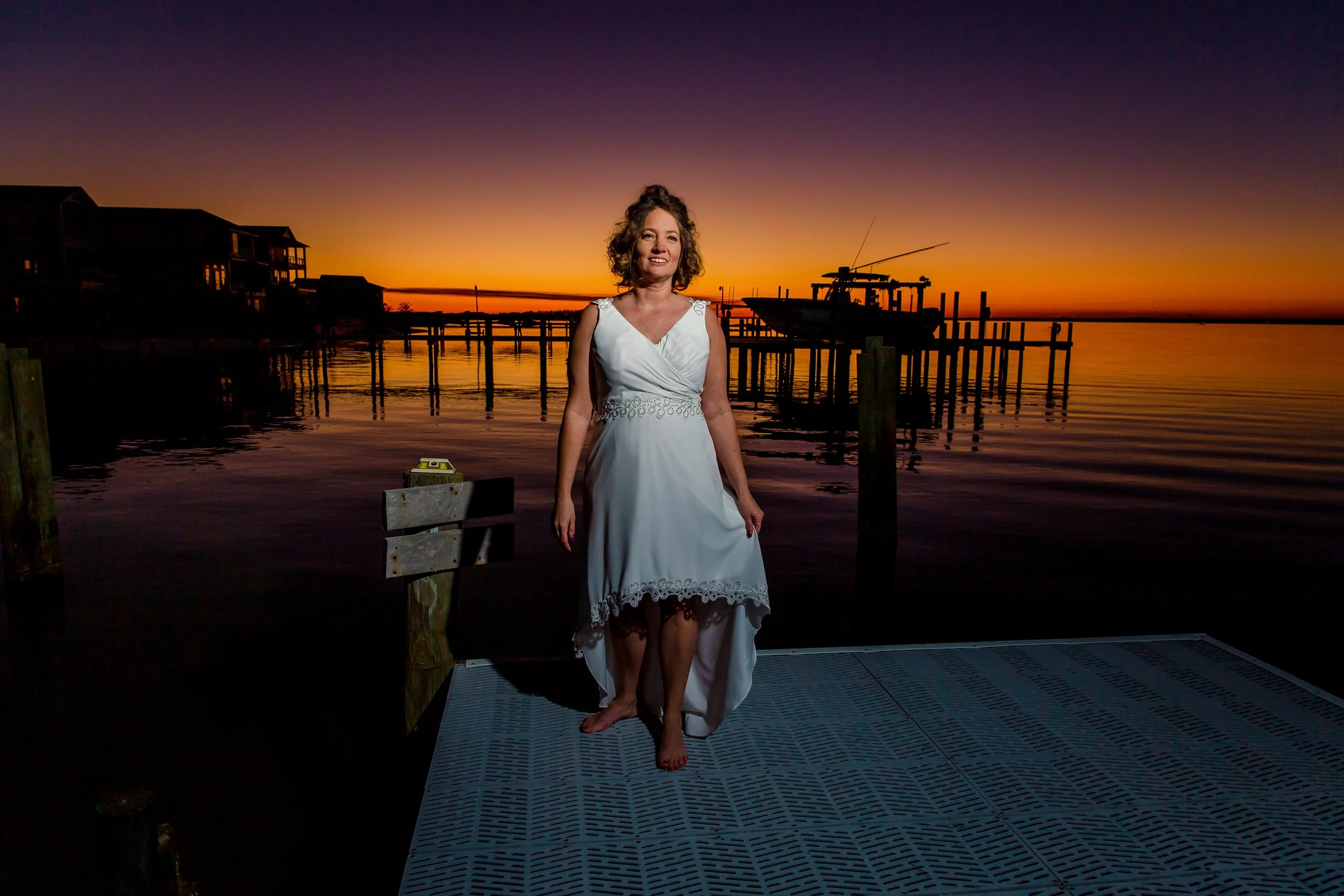 Bridal portraits taken at sunset on a Navarre beach dock by a Jacksonville and St. Augustine Wedding and Family photographer