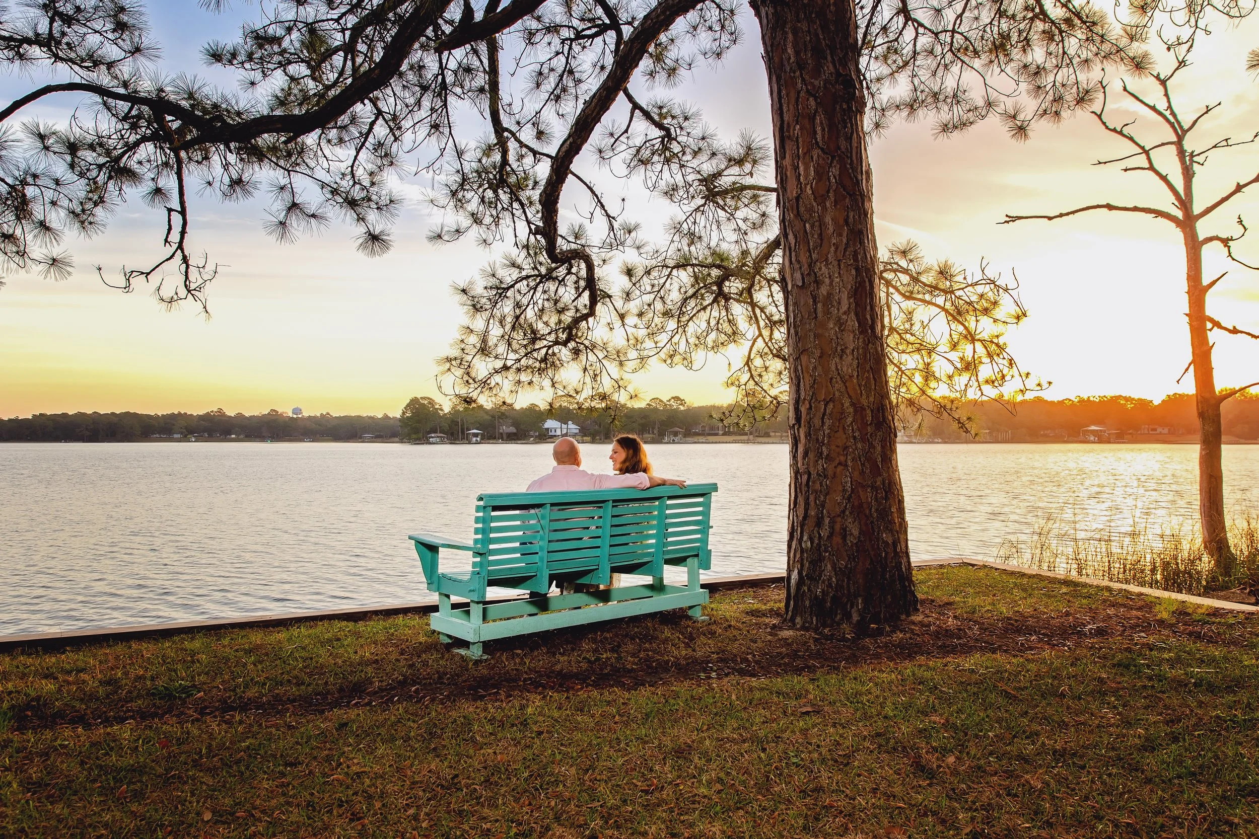 sunset picture of a couple sitting together on a Jacksonville bench