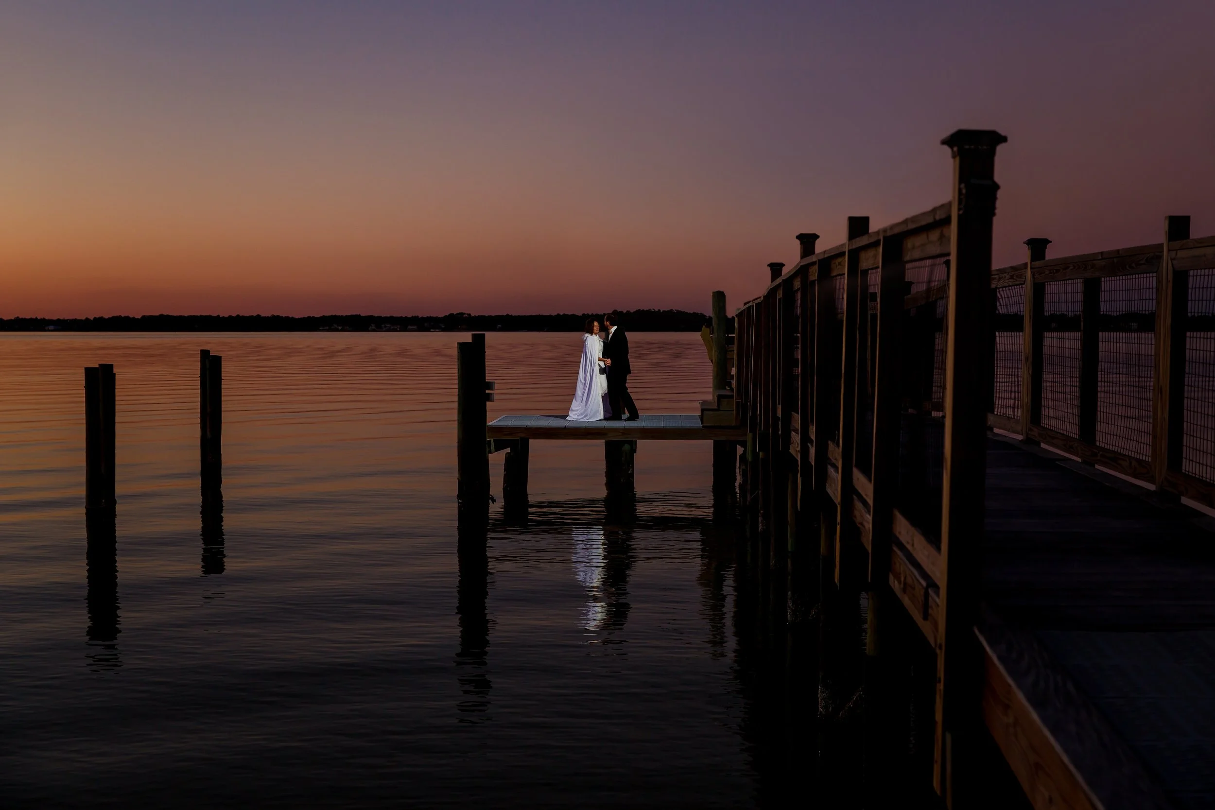 Bride and groom dancing on the dock in Navarre beach Florida taken by a Jacksonville and St. Augustine Wedding photographer