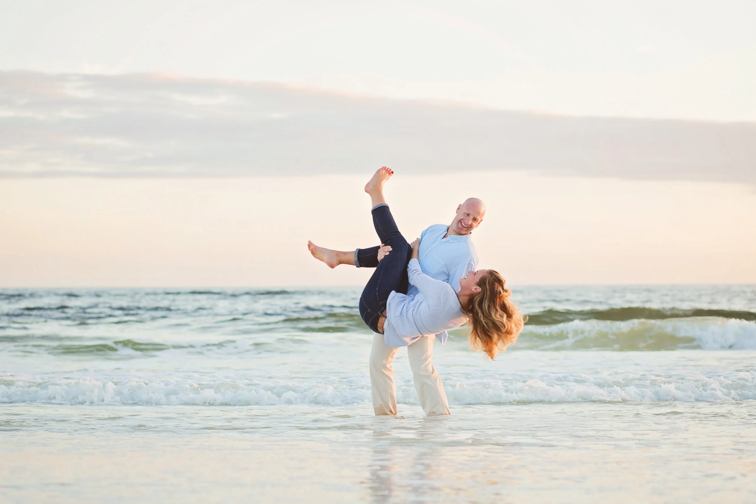 couple on Jacksonville beach pictured playing in the ocean
