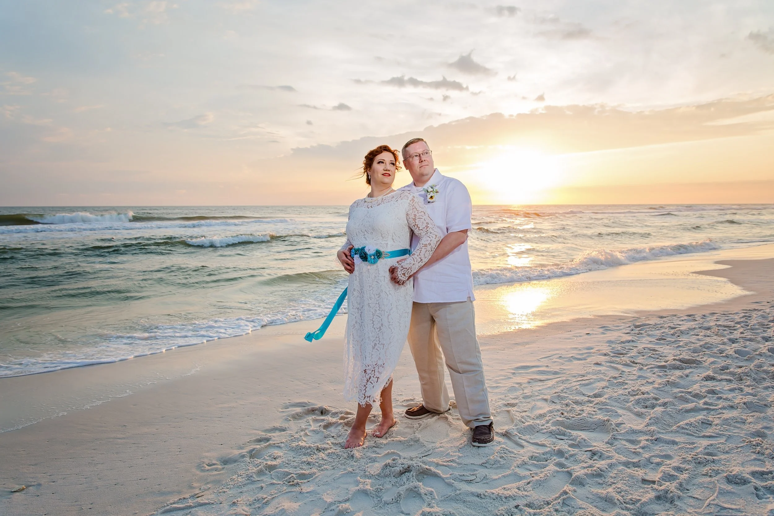 Bride and Groom holding each other on the white sand of Destin Beach Florida photographed by Jacksonville Florida St .Augustine wedding photographer