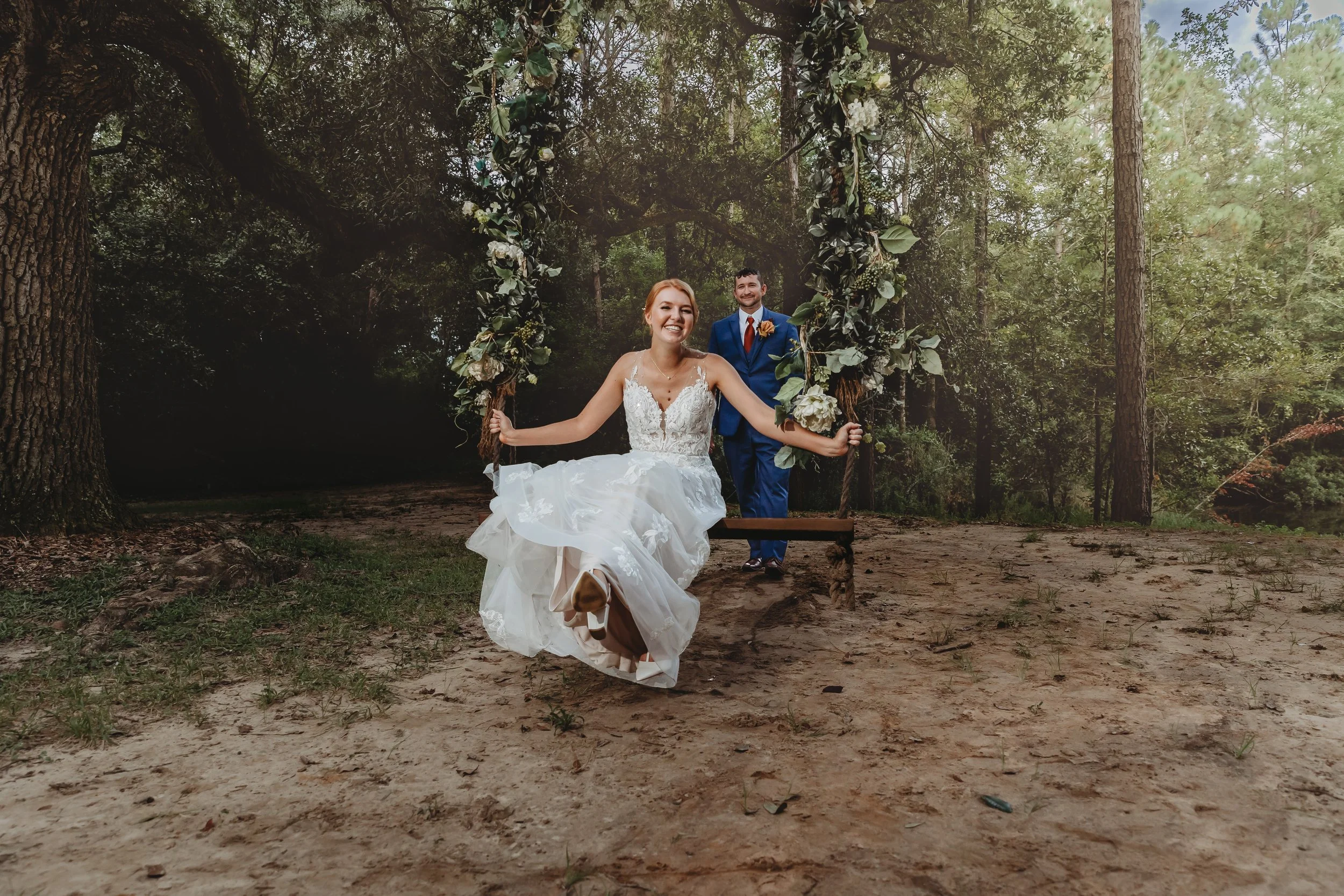bride and groom- swinging wedding pictures at the live oak wedding venue in Pensacola Florida photographed by Jacksonville beach St. Augustine wedding photographer
