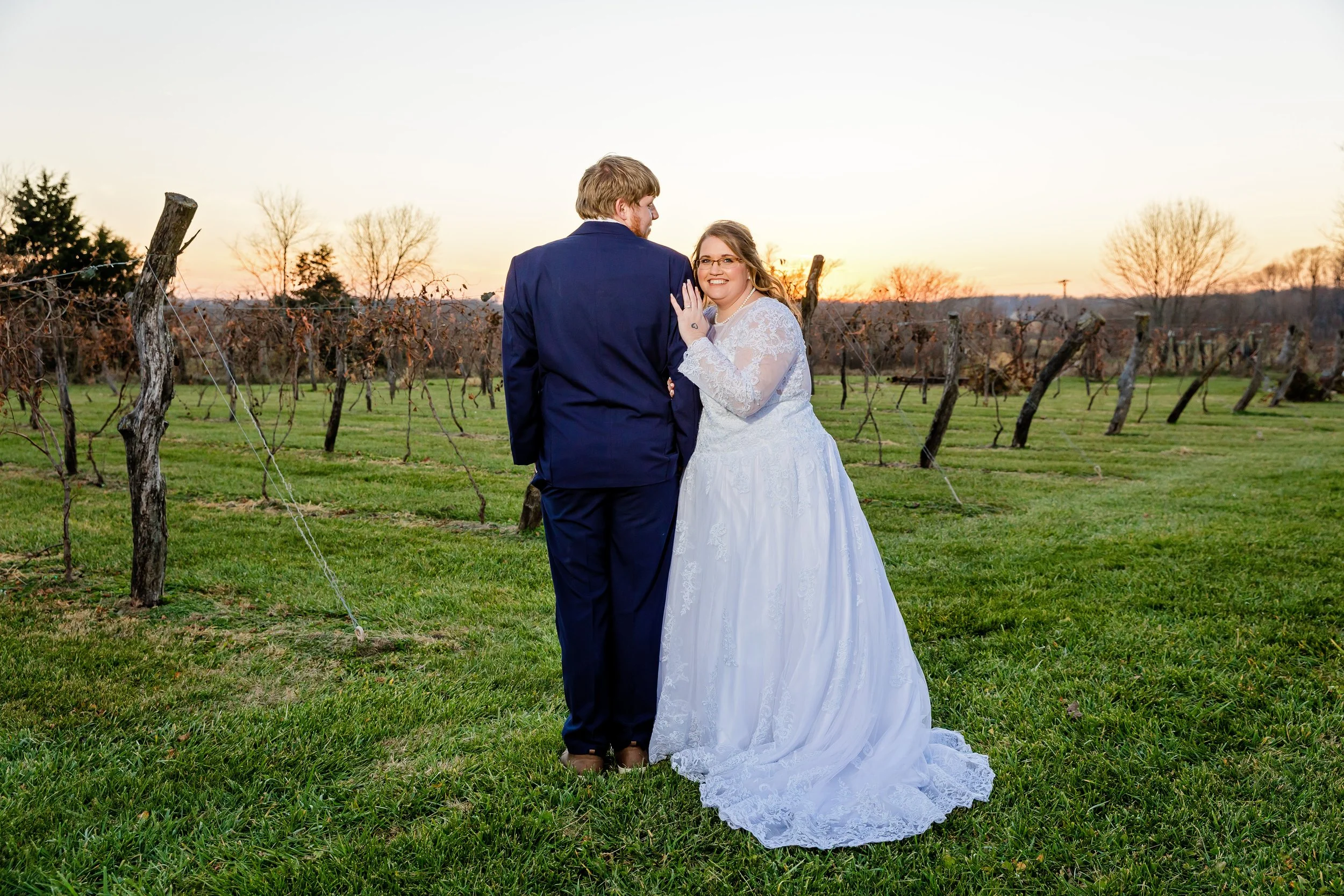 bride and groom portraits next to country field near a grape orchard photo captured by Jacksonville beach St. Augustine Florida wedding photographer