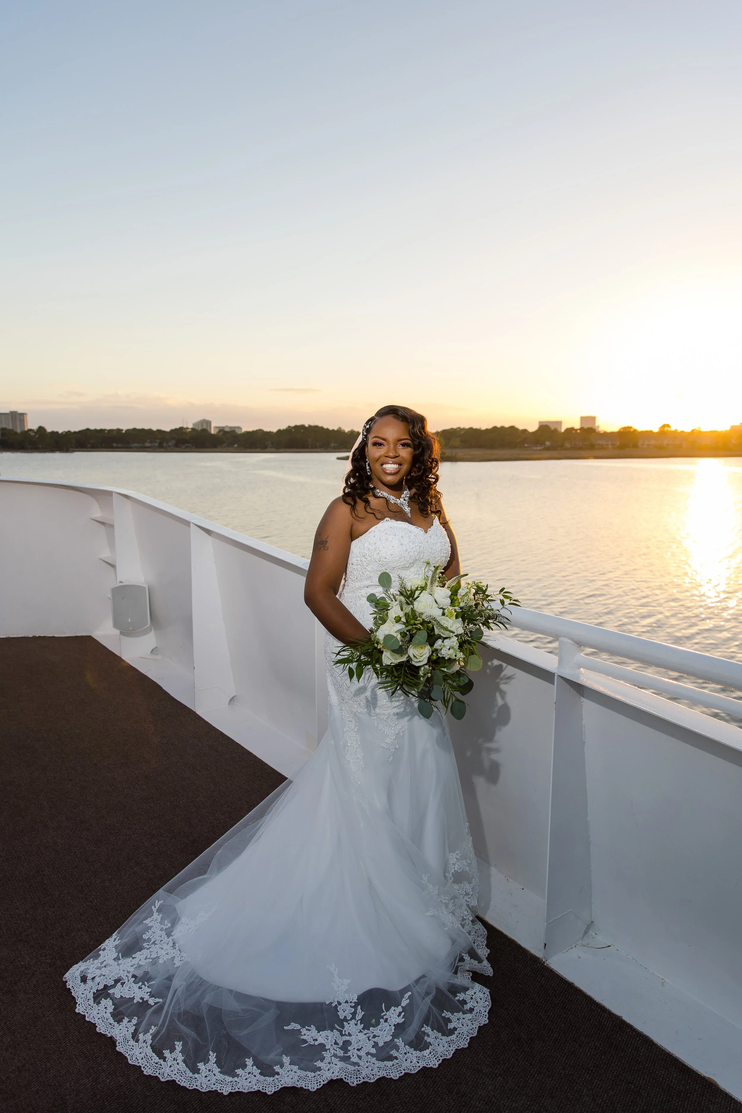 Sunning bride standing on the top deck of a yacht at sunset  photo taken by Jacksonville-Florida St.Augustine-wedding-photographer