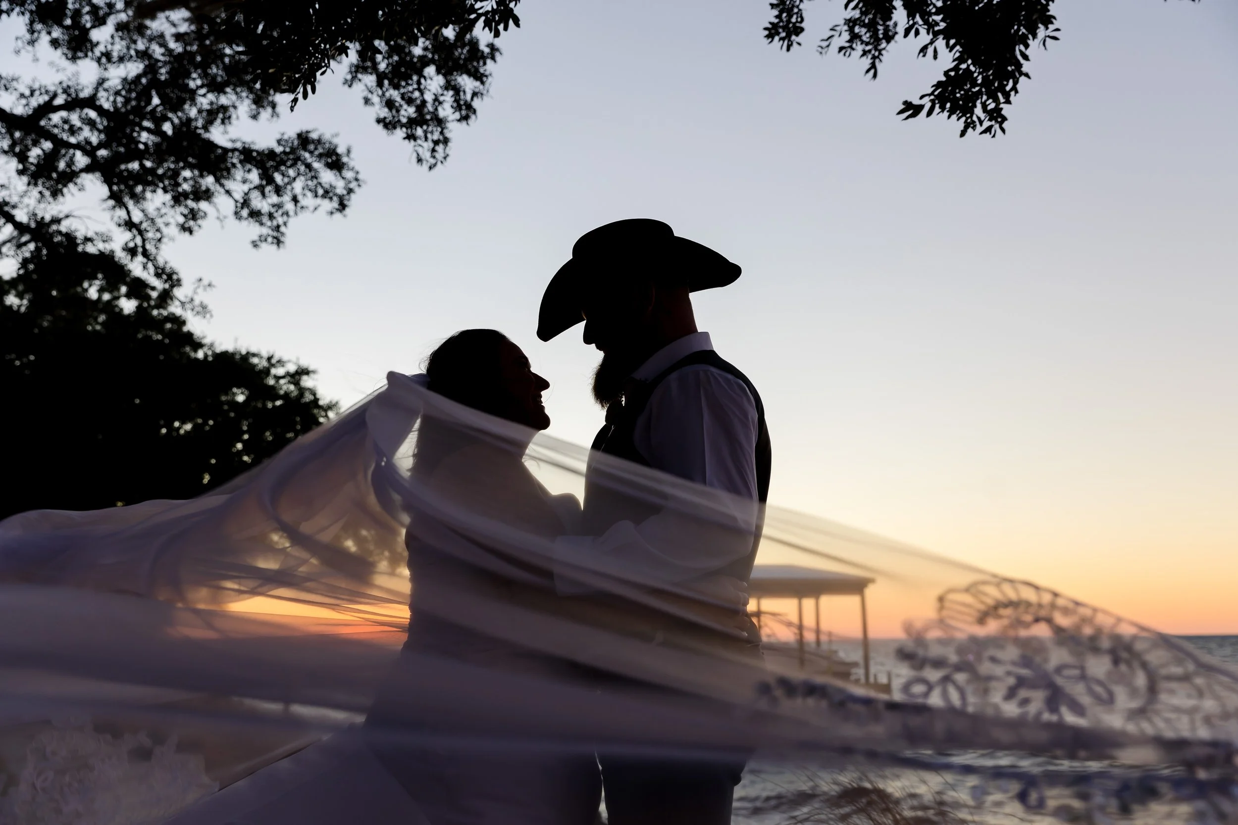 A romantic kissed share by the bride and groom on the lawn at the Bay Front Lodge and Log Cabin in Gulf Breeze picture taken by Jacksonville Beach and St. Augustine Wedding Photographer