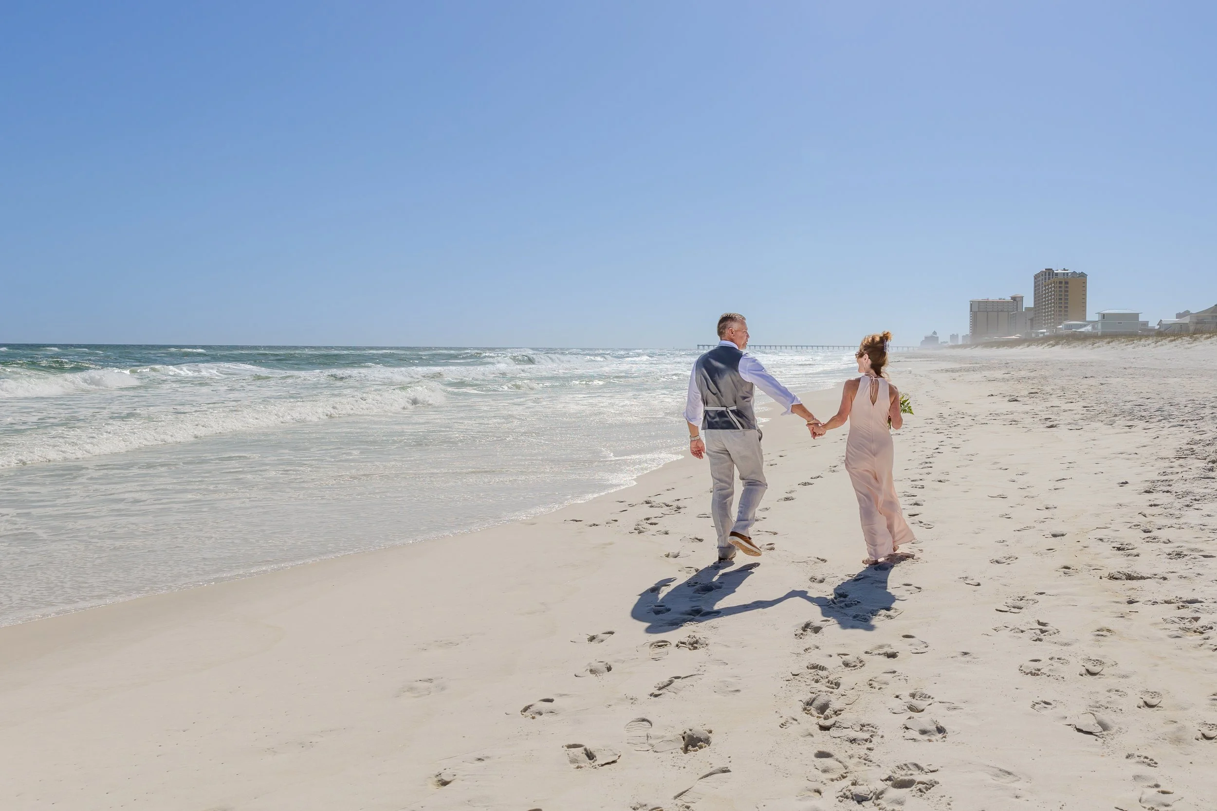 Beautiful sunny Florida beach day with a beautiful Bride and groom standing next to each other captured by Jacksonville beach and St. Augustine Wedding photographer