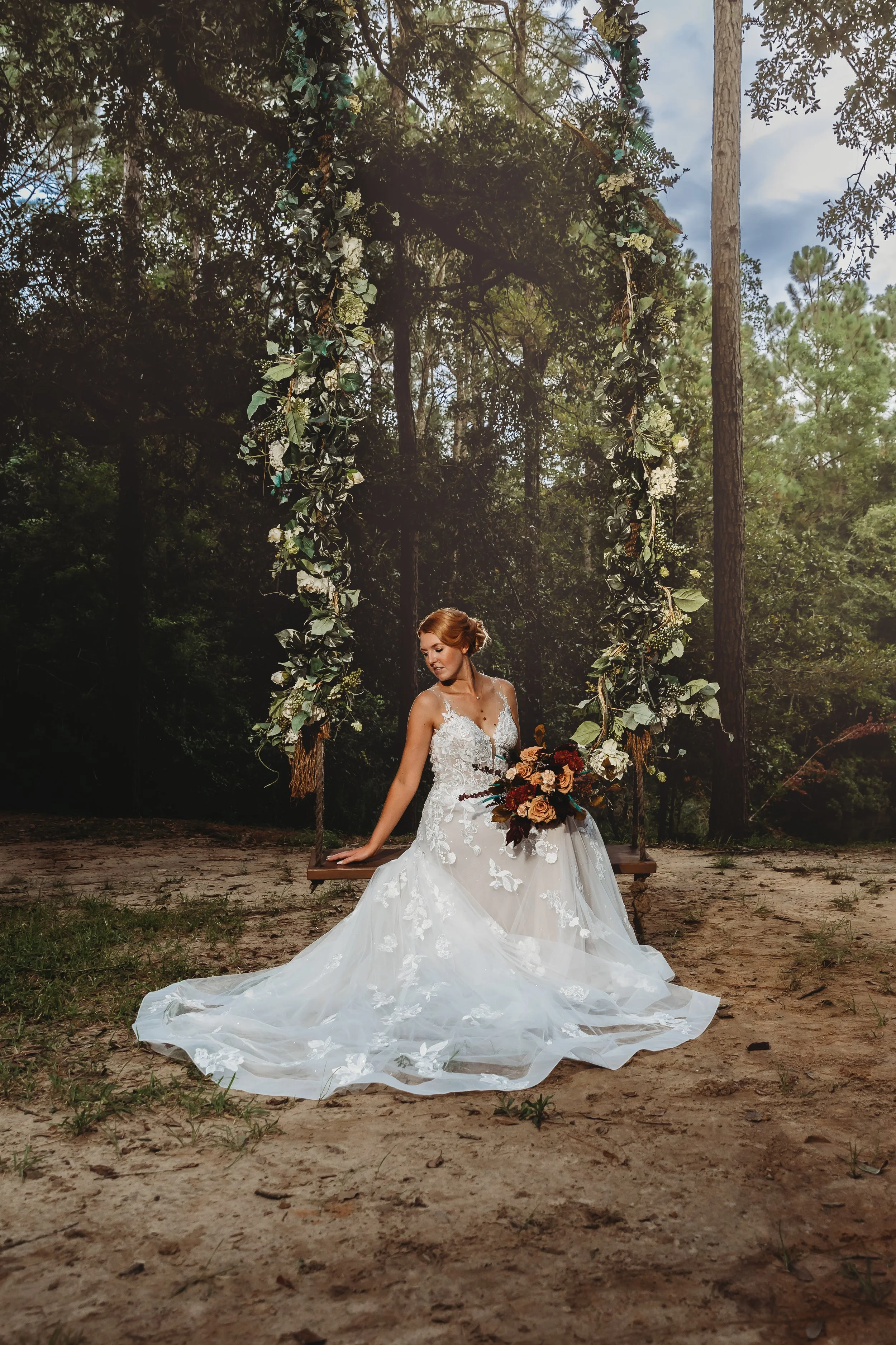 bride sitting on swing wedding pictures at the live oak wedding venue in Pensacola Florida photographed by Jacksonville beach St. Augustine wedding photographer