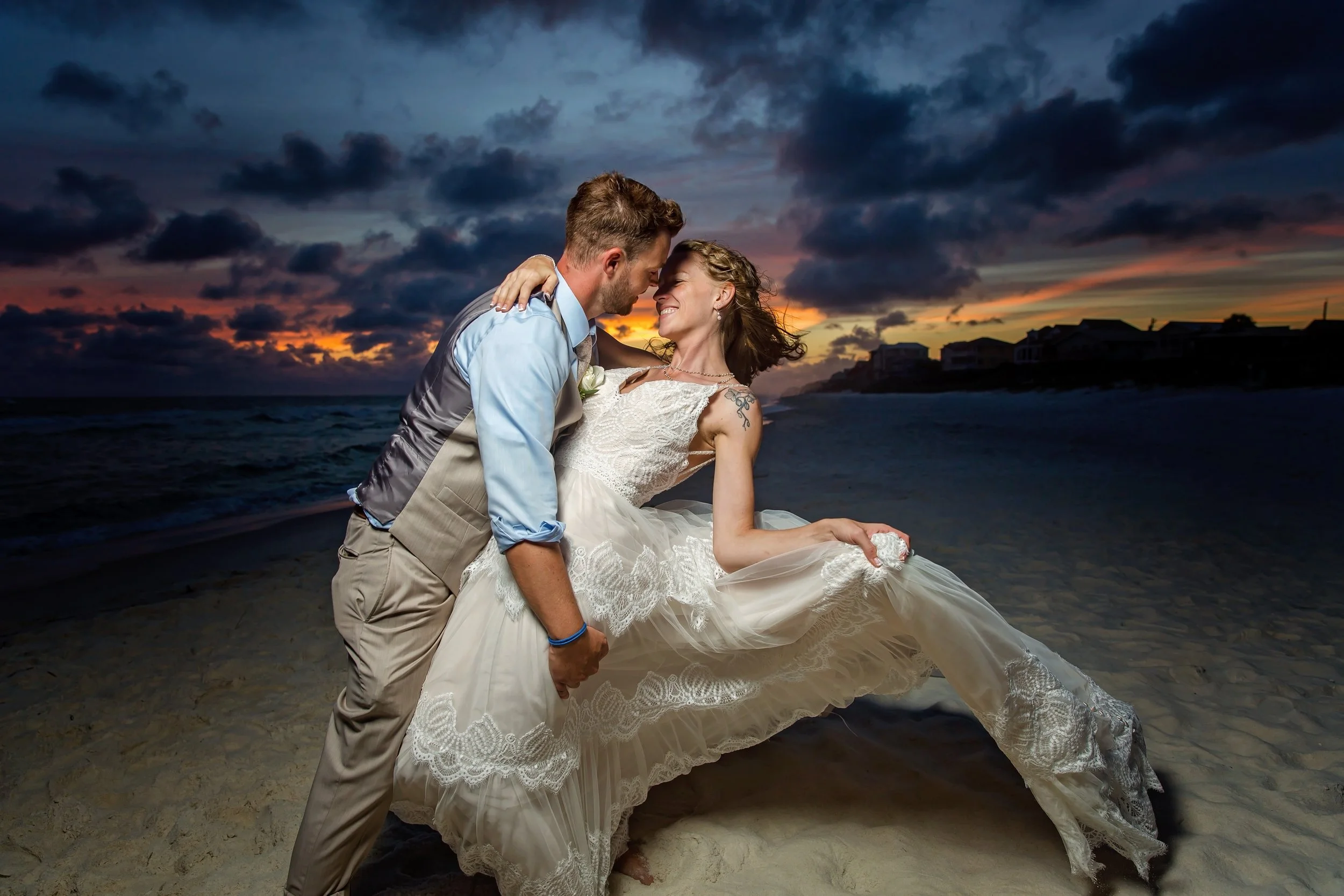 Bride and groom embrace  each other standing on the white sand beach of rosemary beach Florida photographed by Jacksonville, St. Augustine Florida Photographer