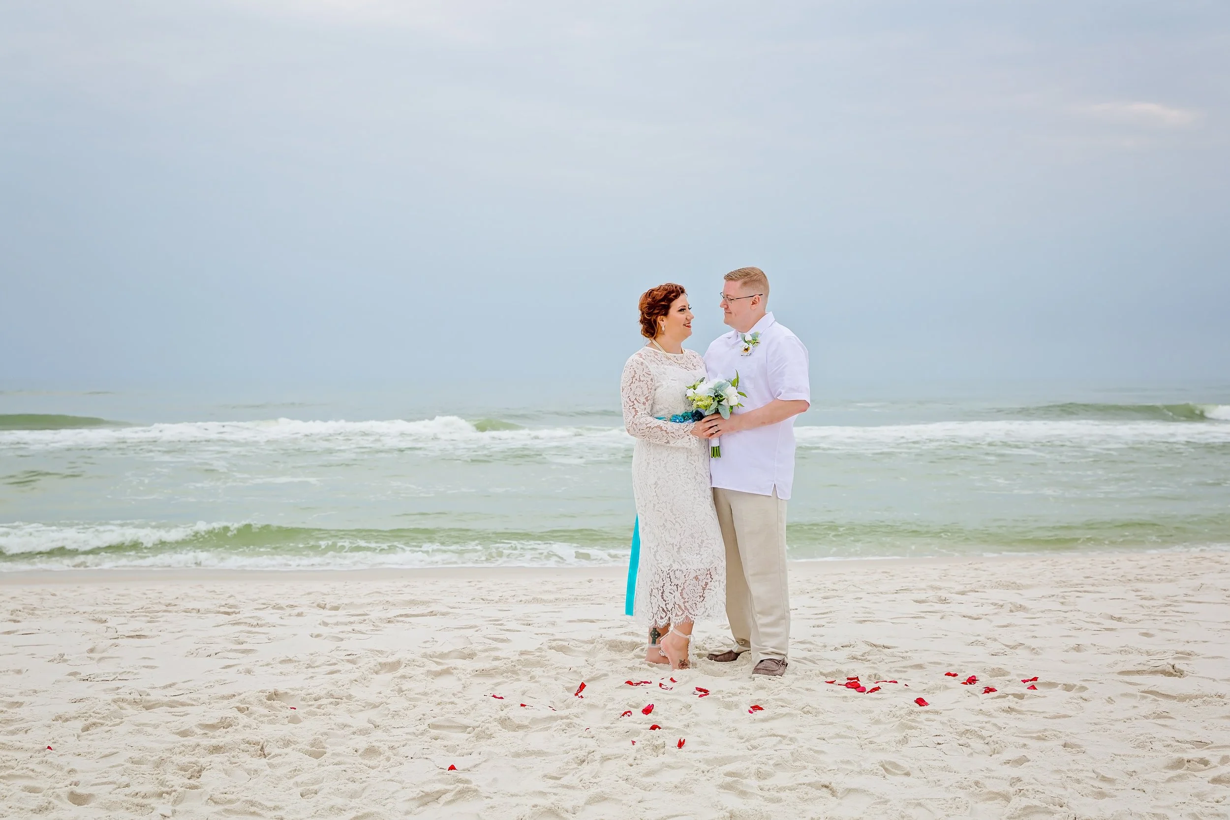 Bride and Groom holding each other on the white sand of Destin Beach Florida photographed by Jacksonville Florida St .Augustine wedding photographer