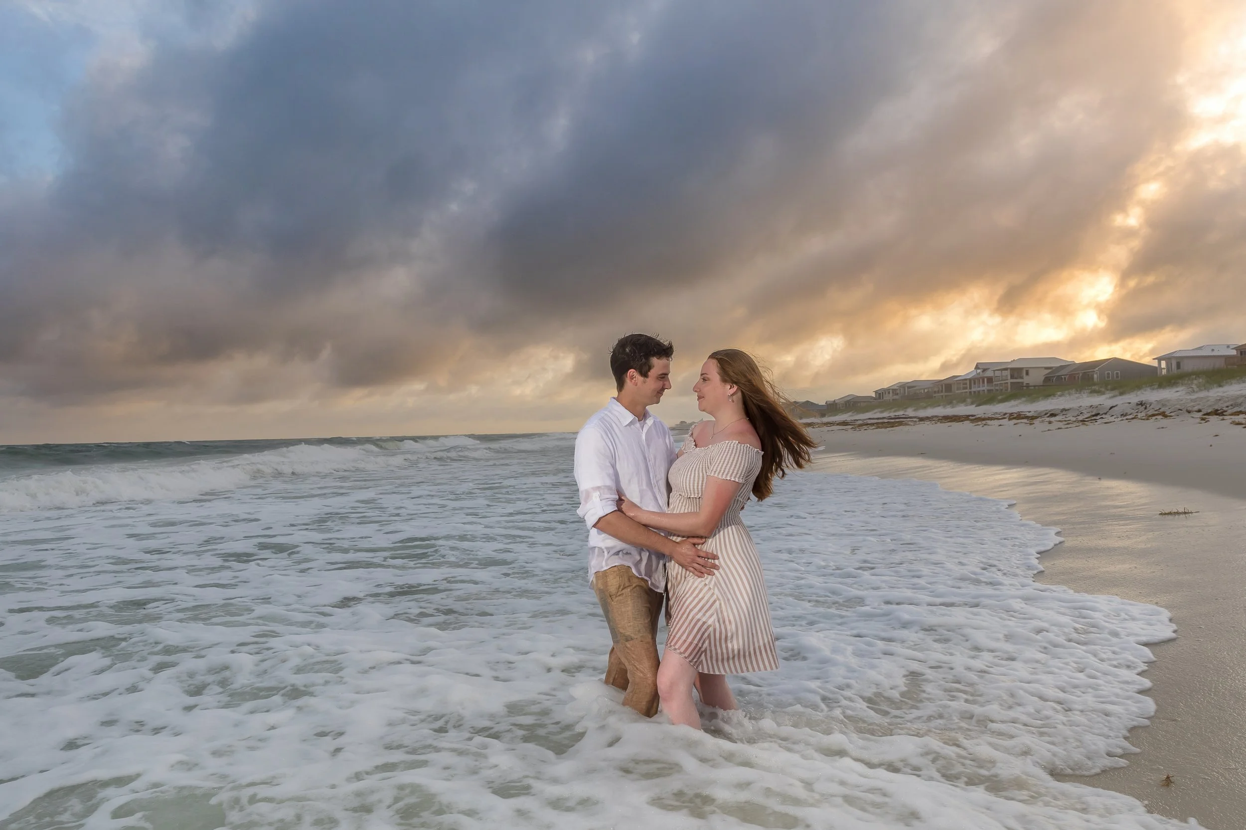 Couple enjoying a beach portrait session with Inspired By You Photography, an affordable Navarre Beach photographer.
