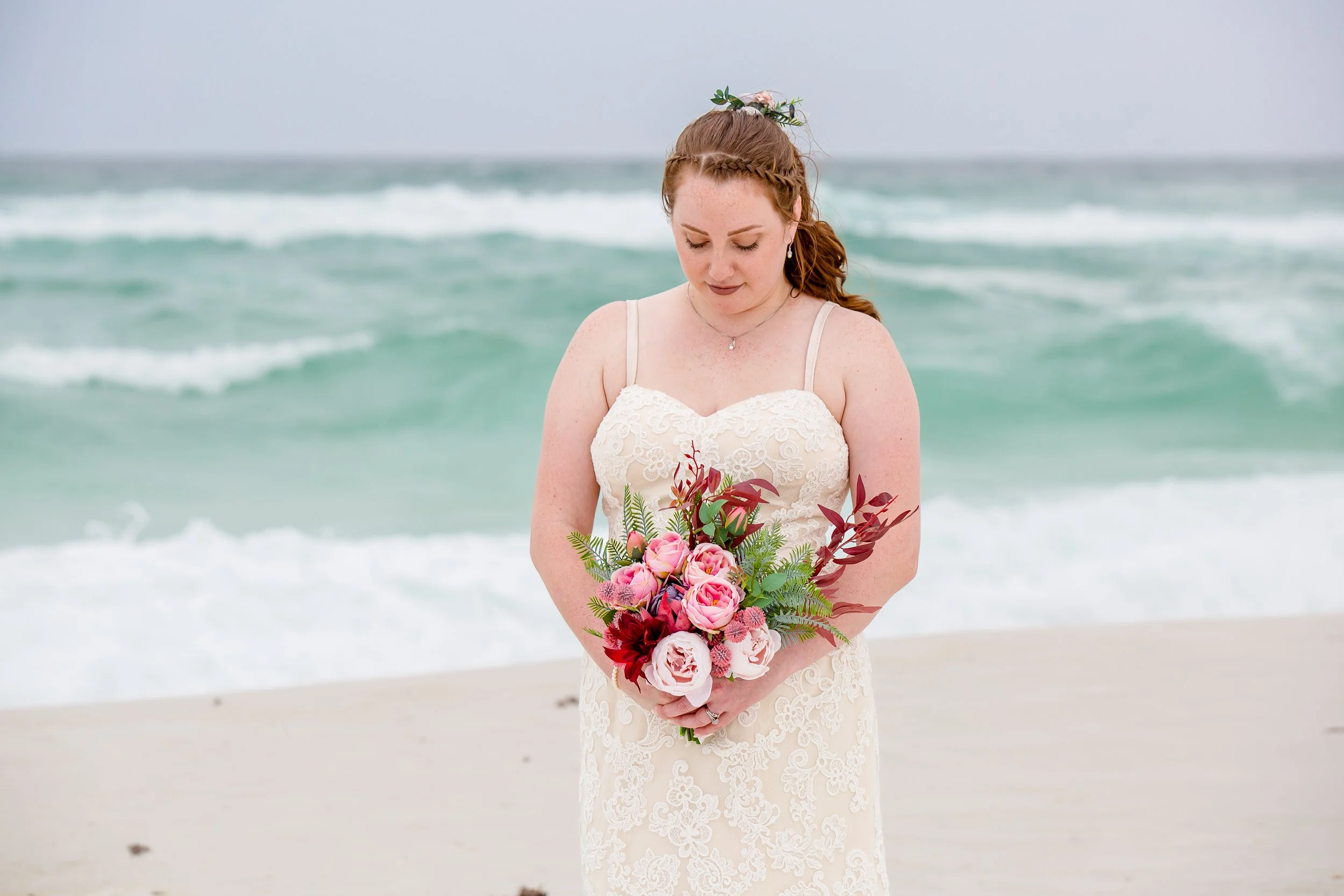 Stunning bride posing for portraits standing on white sandy Navarre beach picture by Jacksonville beach and St. Augustine wedding photographer