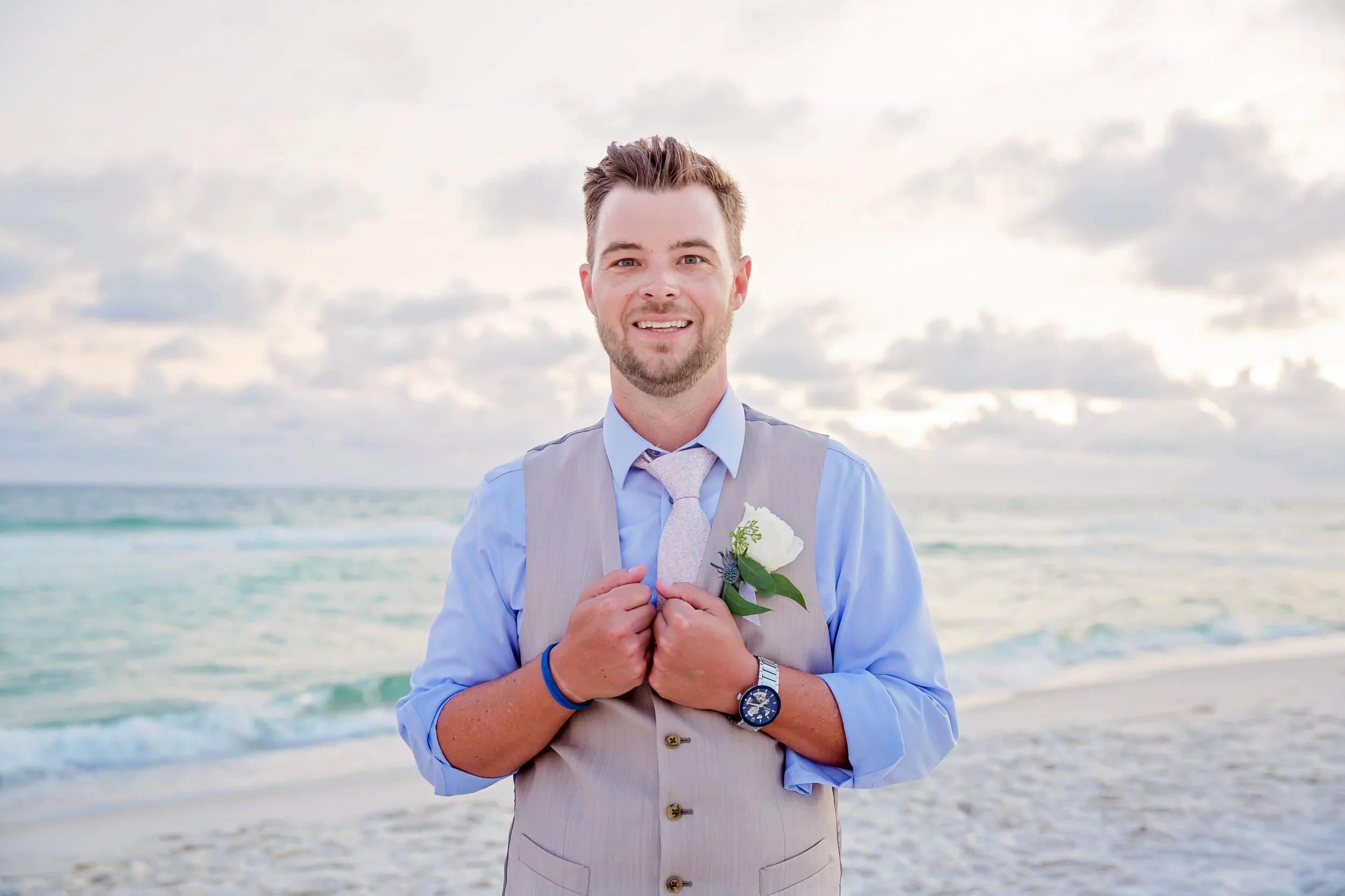 handsome groom standing on the white sand beach of rosemary beach Florida photographed by Jacksonville, St. Augustine Florida Photographer