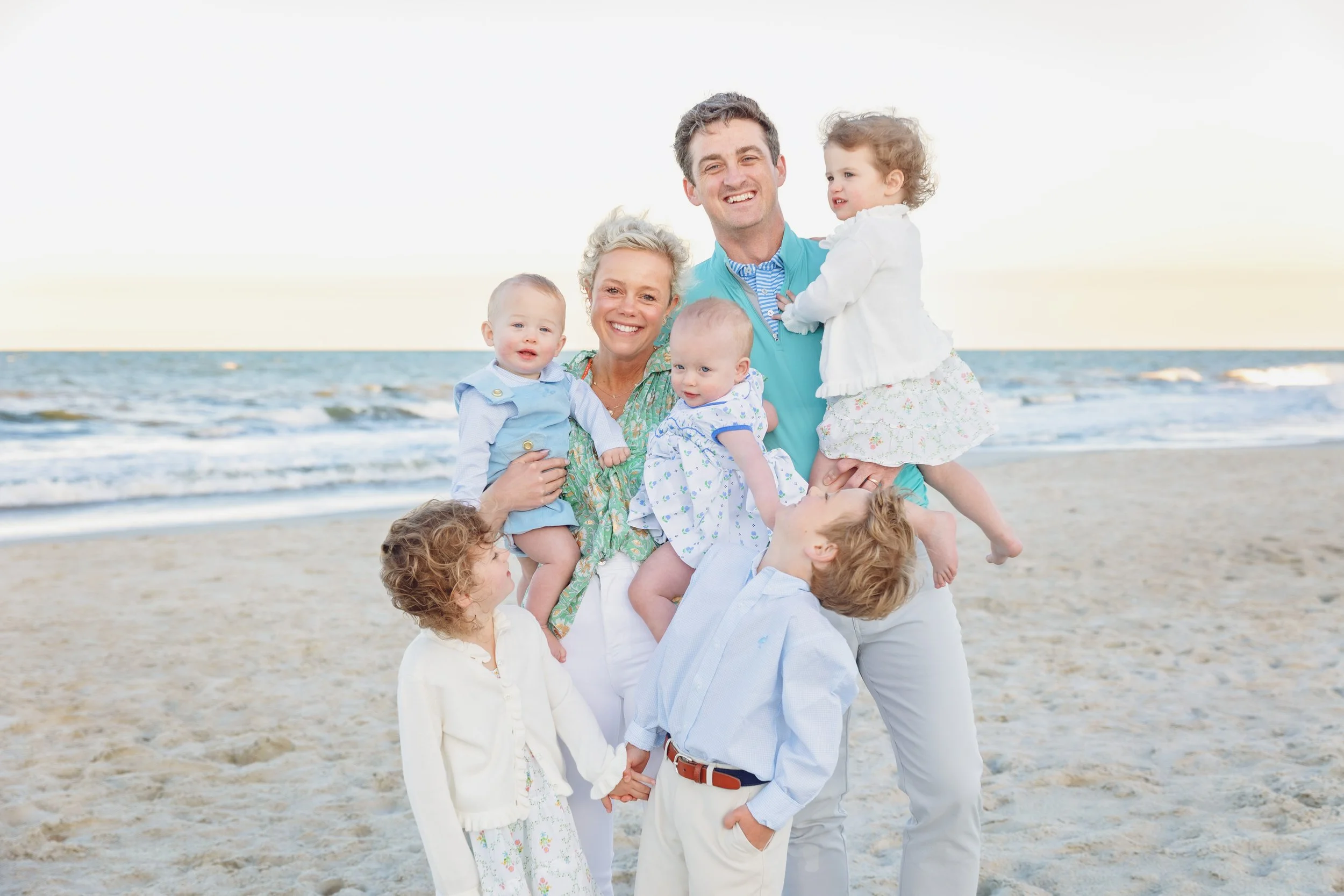Beautiful family taking sunset images on Navarre beach by Inspired By You Photography