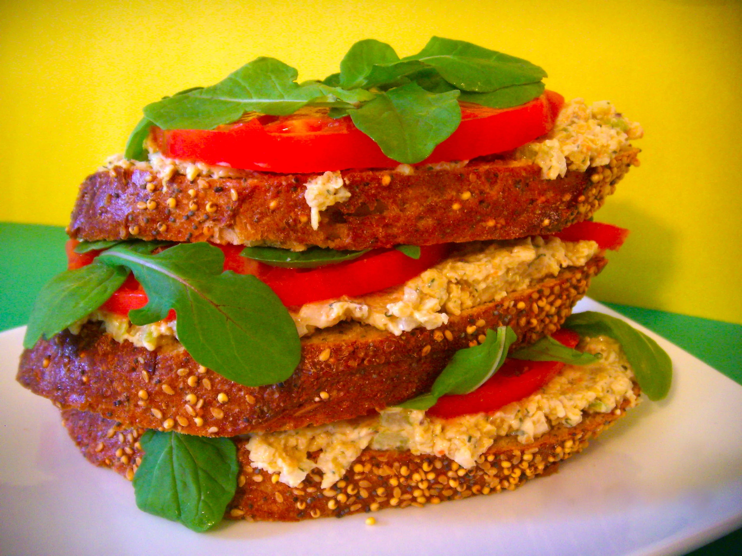   open-faced tu-no-fish sandwiches on seeduction bread, heirloom tomatoes, arugula  